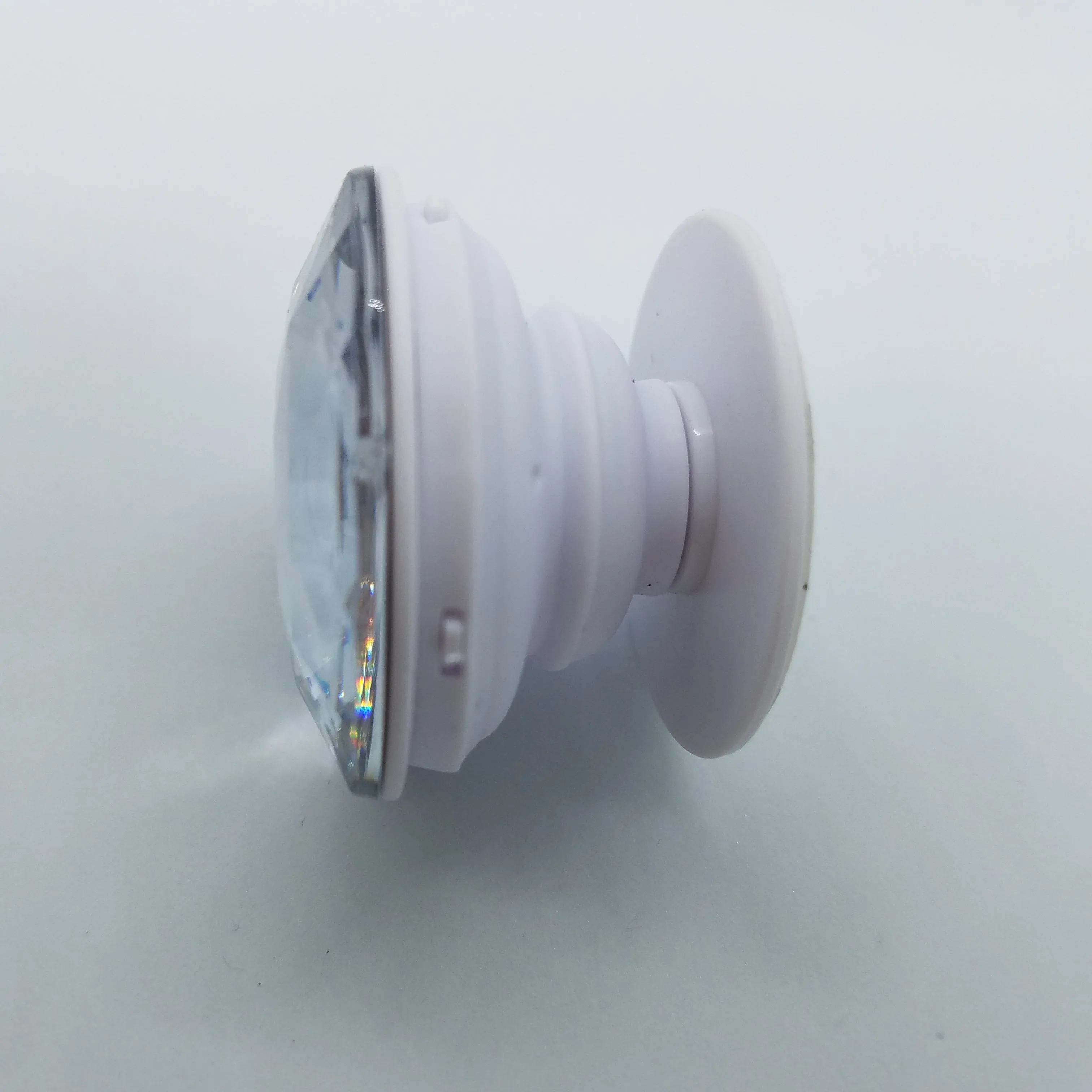 Plastic jewel pop up stand and grip